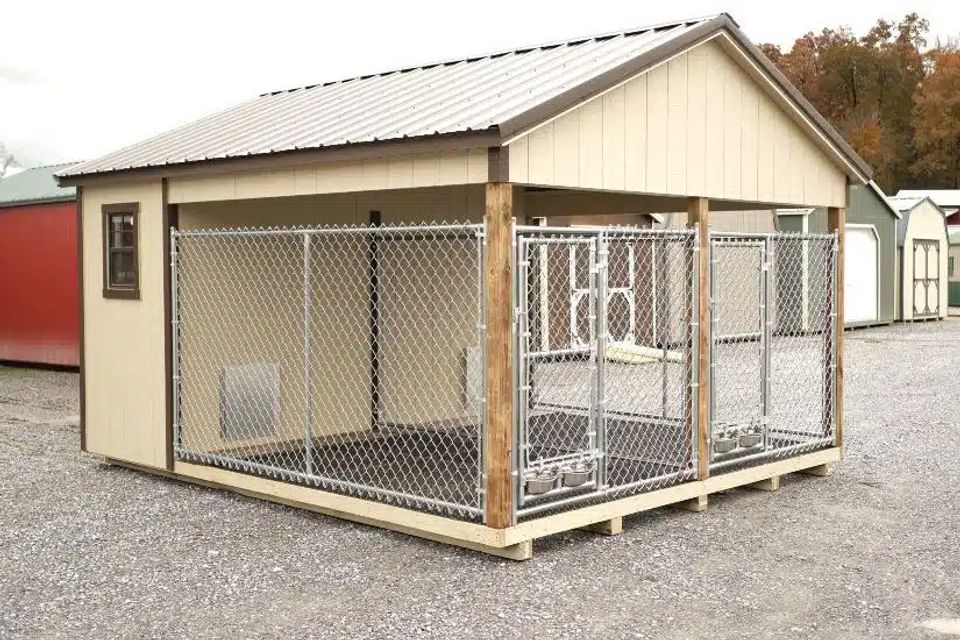 Tan dog kennel with double chain link runs and covered roof on an East Tennessee lot