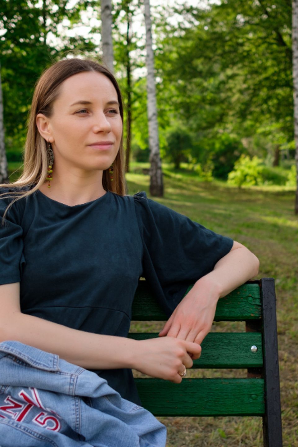 Young woman relaxing park sitting chair