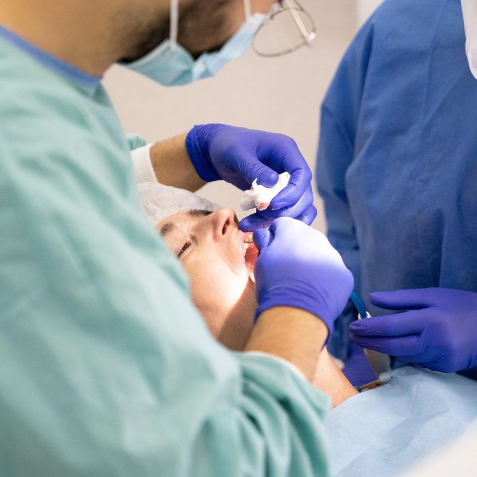 Orthodontist cleaning a patients teeth