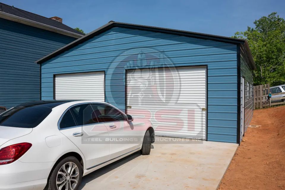 Blue steel garage with white roll up doors and side windows with SBSI watermark representing steel garages in Alabama
