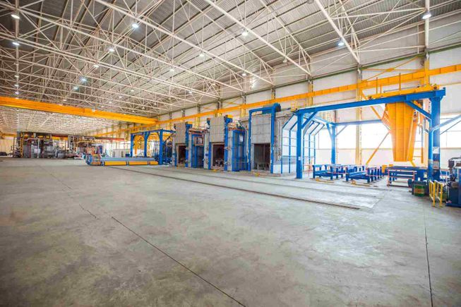 Metallic ovens inside big factory with heavy equipments