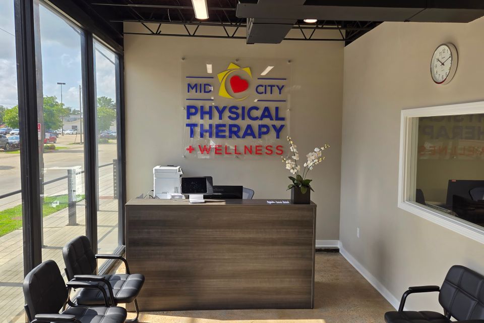 Front desk and interior signage at Mid-City Physical Therapy's Metairie clinic