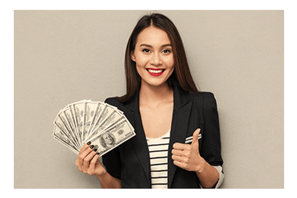 Thumbs up women with cash