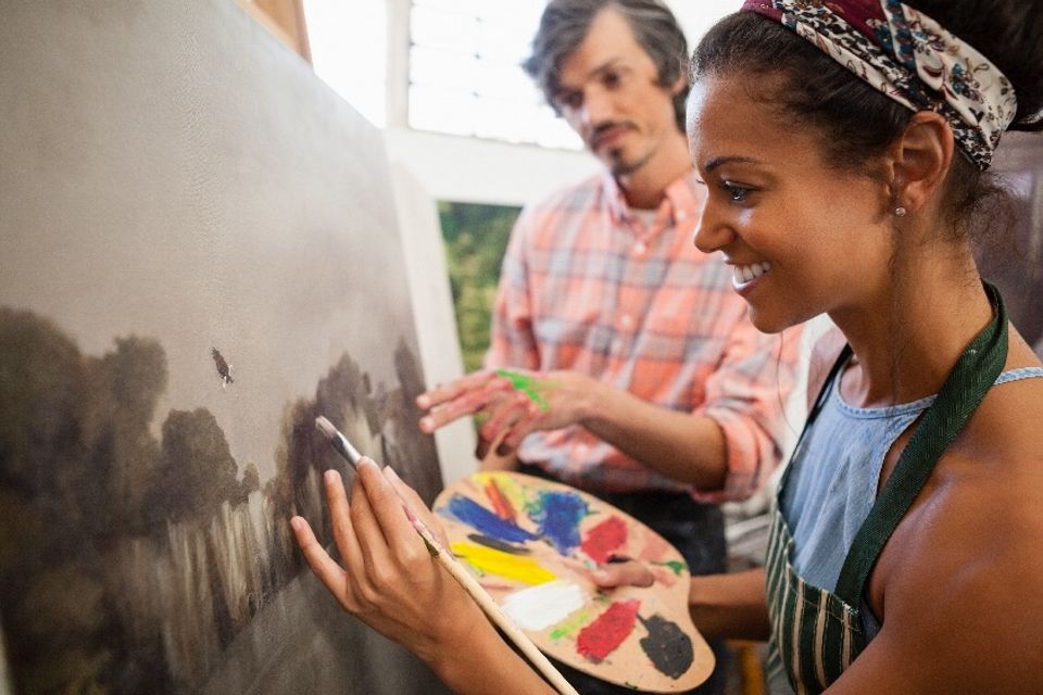 Man assisting woman in painting 2023 11 27 04 57 35 utc