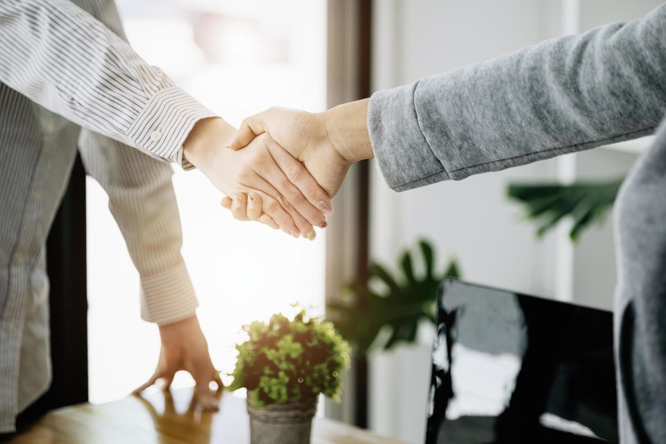Businesswoman handshake for teamwork of business merger and acquisition successful negotiate hand shake two business woman shake hand with partner to celebration partnership and business deal concept free photo