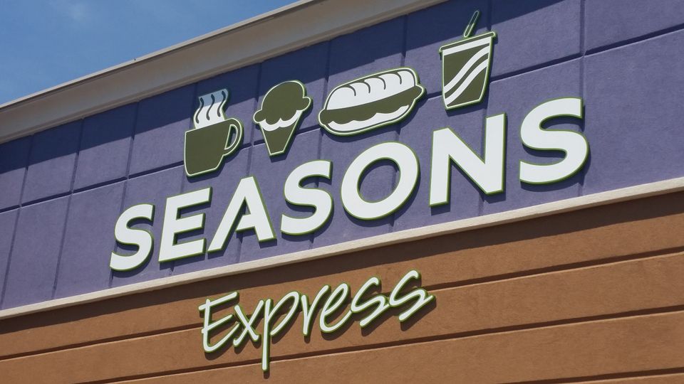 Dimensional letters reading Seasons Express with food icons mounted on a storefront facade