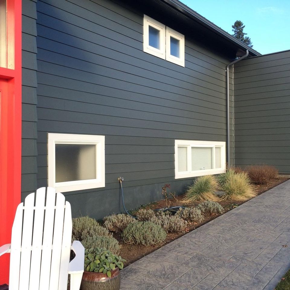 Dark blue home side exterior landscaping