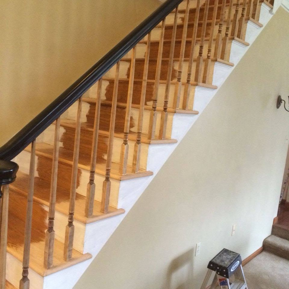 Hardwood staircase and black handrail
