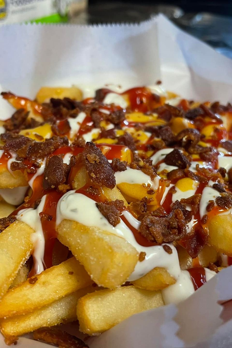 Fries topped with bacon bits and dressings from Inferno The Restaurant in Sound Beach