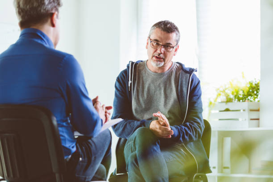 Man in one-on-one therapy session discussing personal growth and mental health