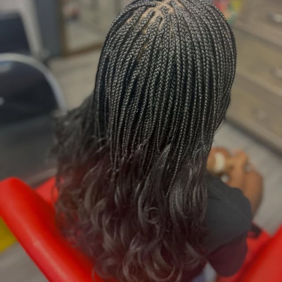 Overhead view of small knotless braids with curly ends after a braiding service in Los Angeles CA