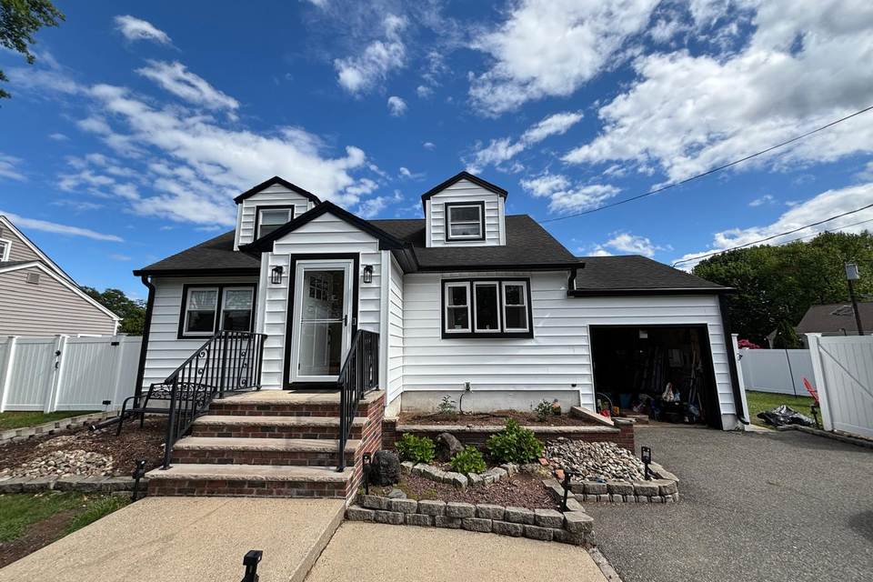 house with white siding and custom masonry work