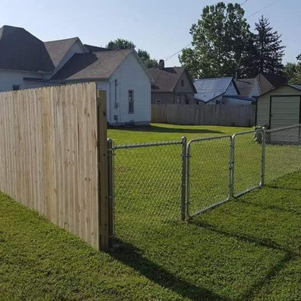 transitioning wooden privacy fence with chain link and double gate