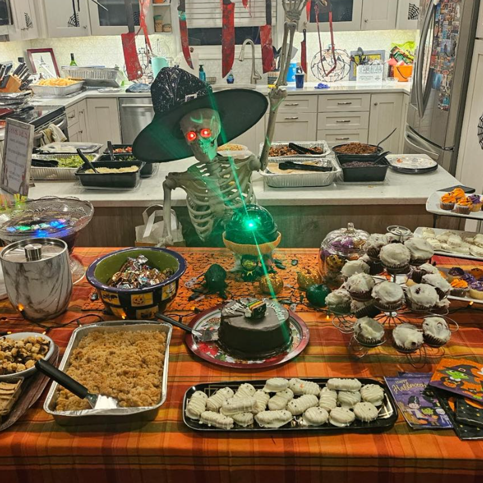 alt="The Party Savers staff bartending and waitressing at a Halloween-themed event"