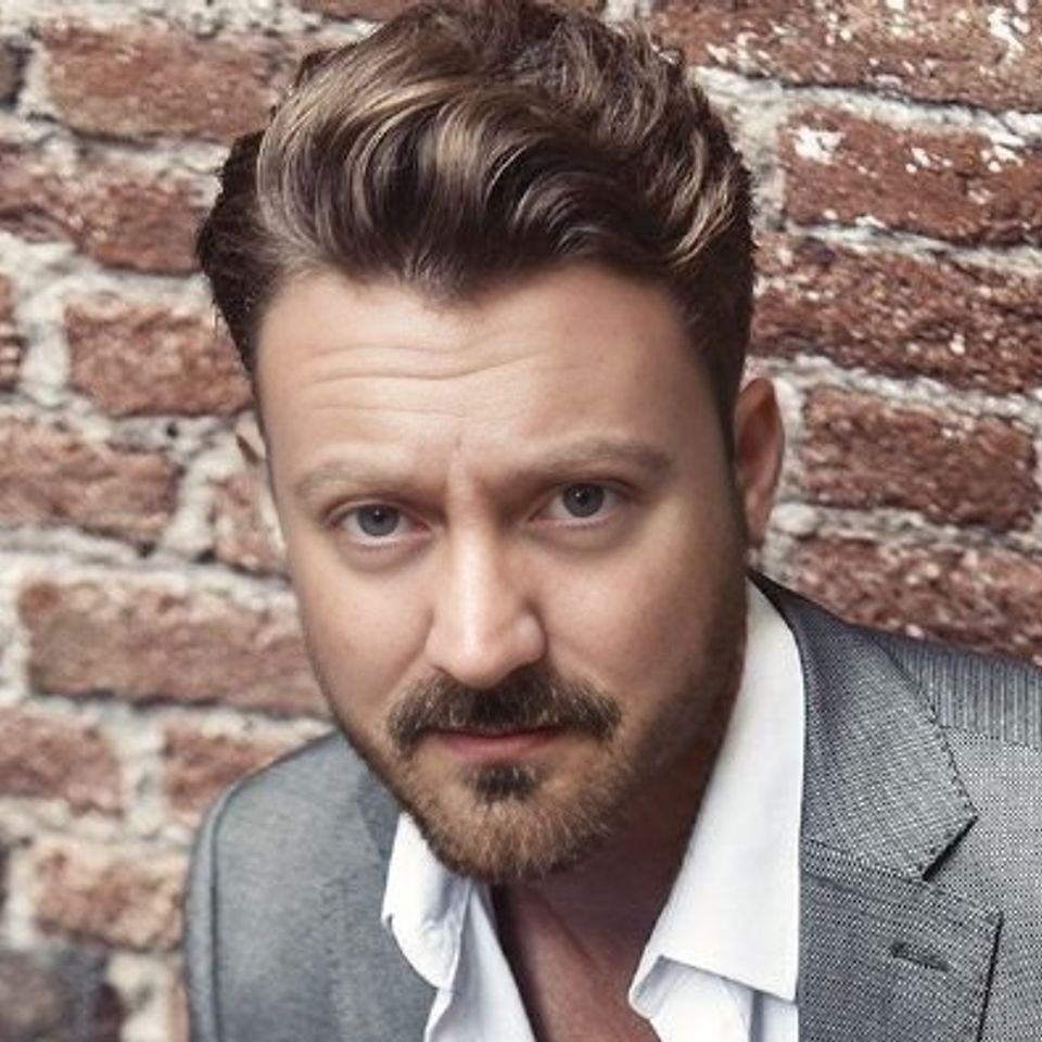 Me headshot grey suit open shirt cropped