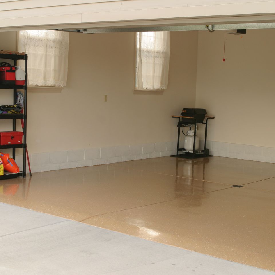 Residential garage featuring an EverCoat Flooring system with a seamless decorative finish.
