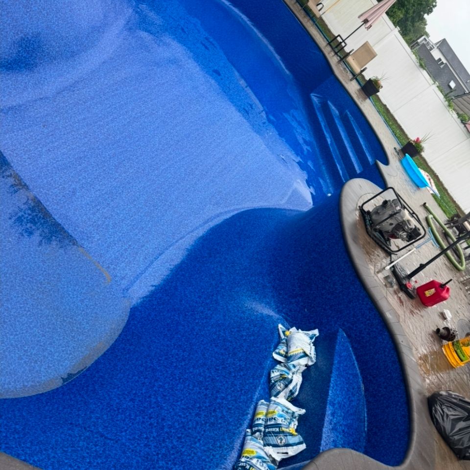 Fresh blue pool liner set with sandbags while the pool fills during a Long Island liner replacement