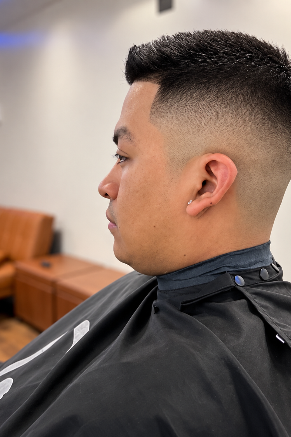This image shows a man posing after a fresh haircut.