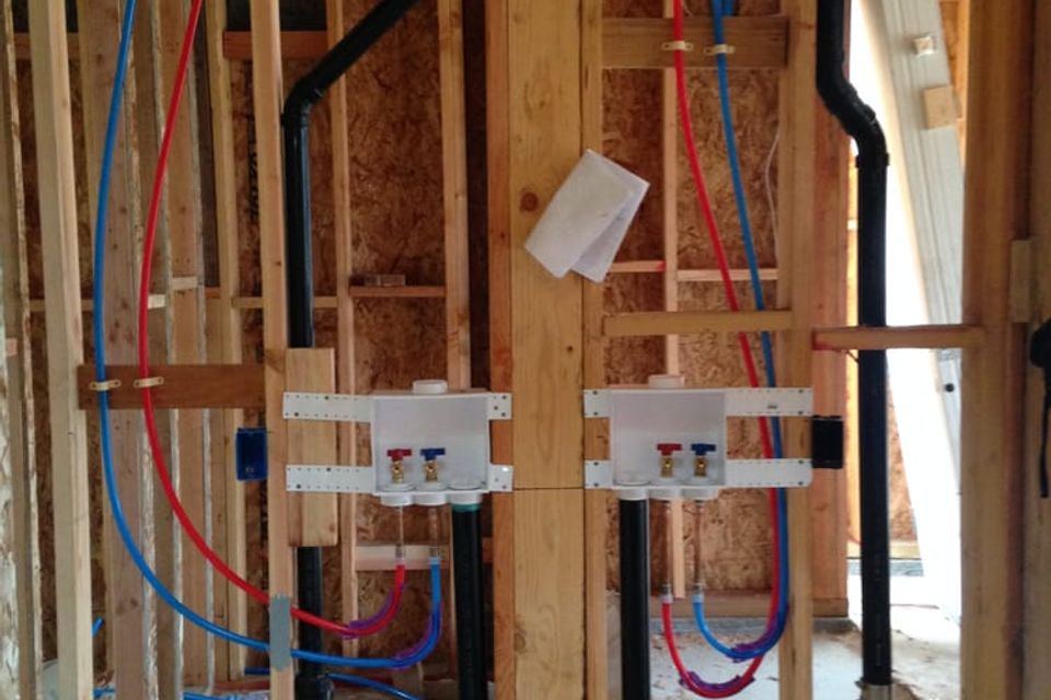 laundry room roughed in with Uponor Pex Pipe for hot and cold water lines and ABS for sewer and vent systems