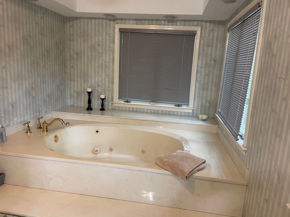 Spotless soaking tub and tiled surround after a house cleaning service in Virginia Beach VA