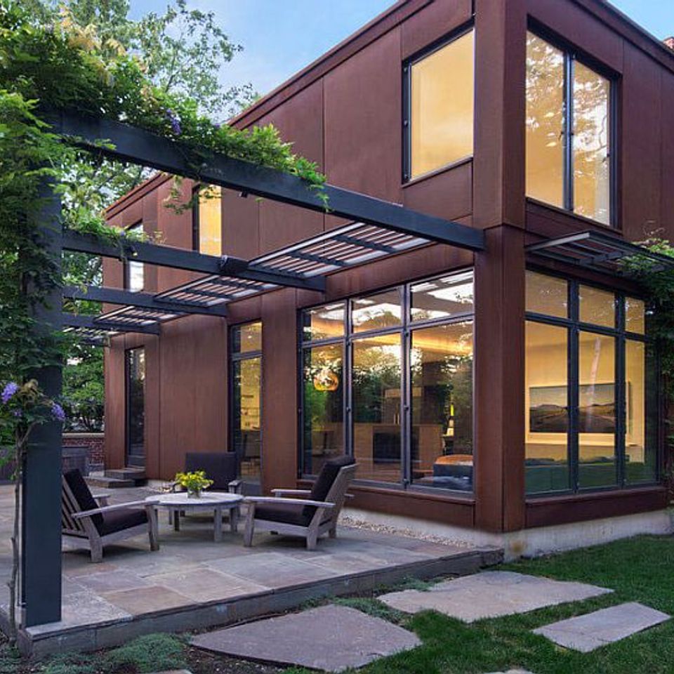 Modern cor ten steel and glass extension for classic fayerweather street residence