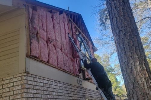 Insulation exposed after removing damaged siding in Galveston, TX