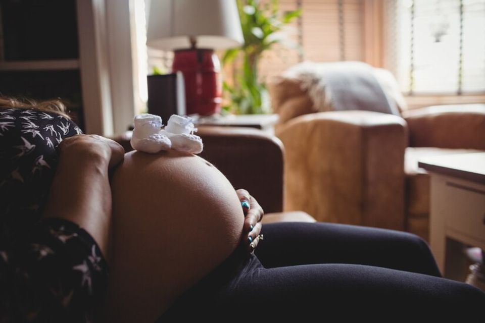 Pair baby socks pregnant woman stomach living room 107420 12188