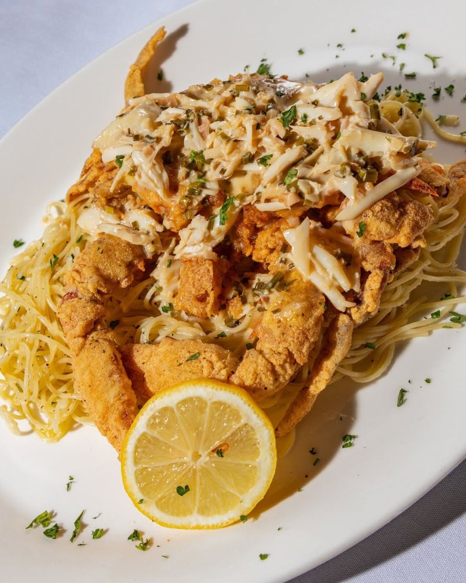 Golden, crispy soft-shell crab atop silky pasta, brightened with fresh lemon.