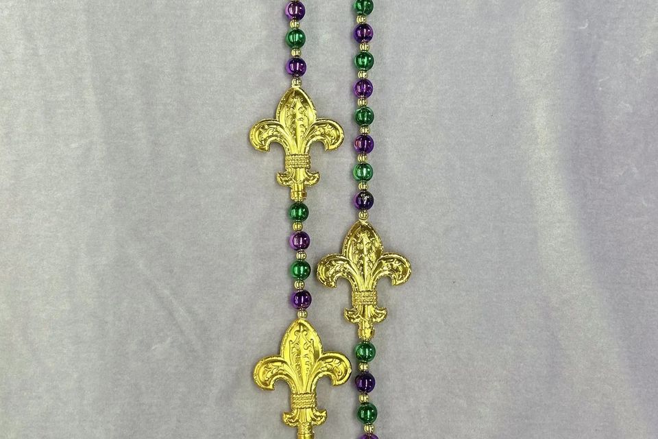 Long purple, green and gold bead with gold fleur de lis emblems