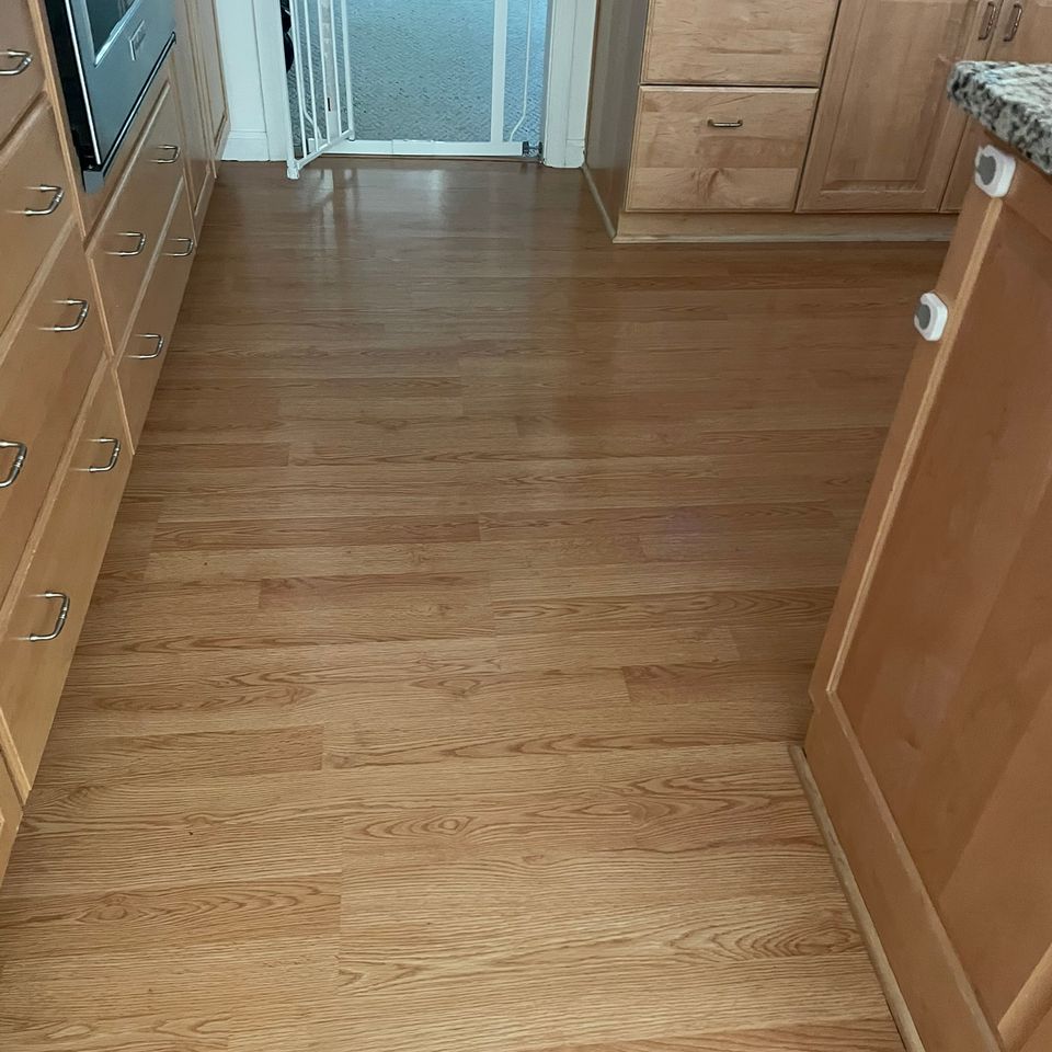 Spotless kitchen wood floor with baby gate after house cleaning service in Virginia Beach VA