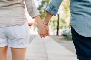 A couple holding hands going to therapy