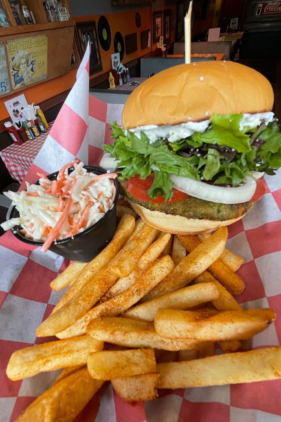Burger with coleslaw and fries from Inferno The Restaurant in Sound Beach