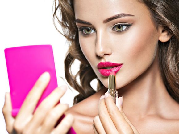 Applying a beautiful shade of lipstick, top name brands are available.