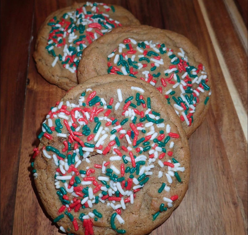 Three gingerbread Christmas cookies with red, white and green sprinkles.