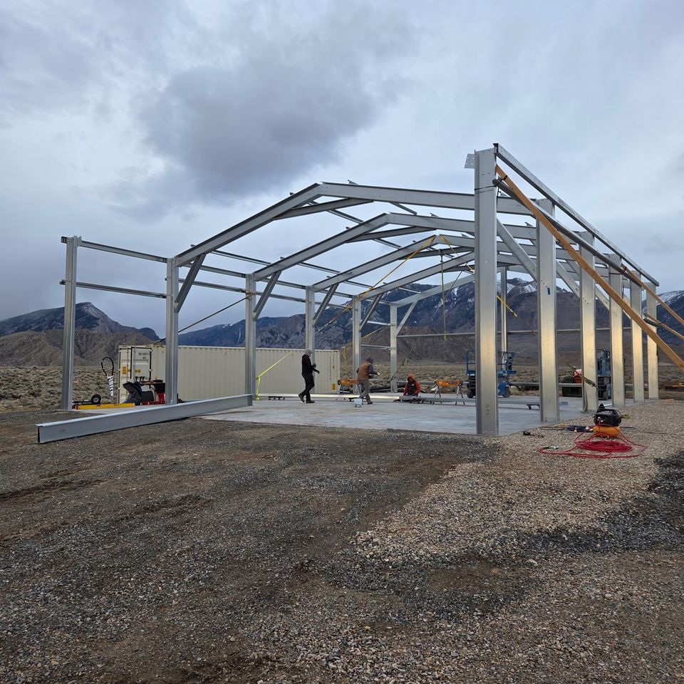 Steel building frame with rigid gable trusses erected during metal building construction in Trout Creek MT