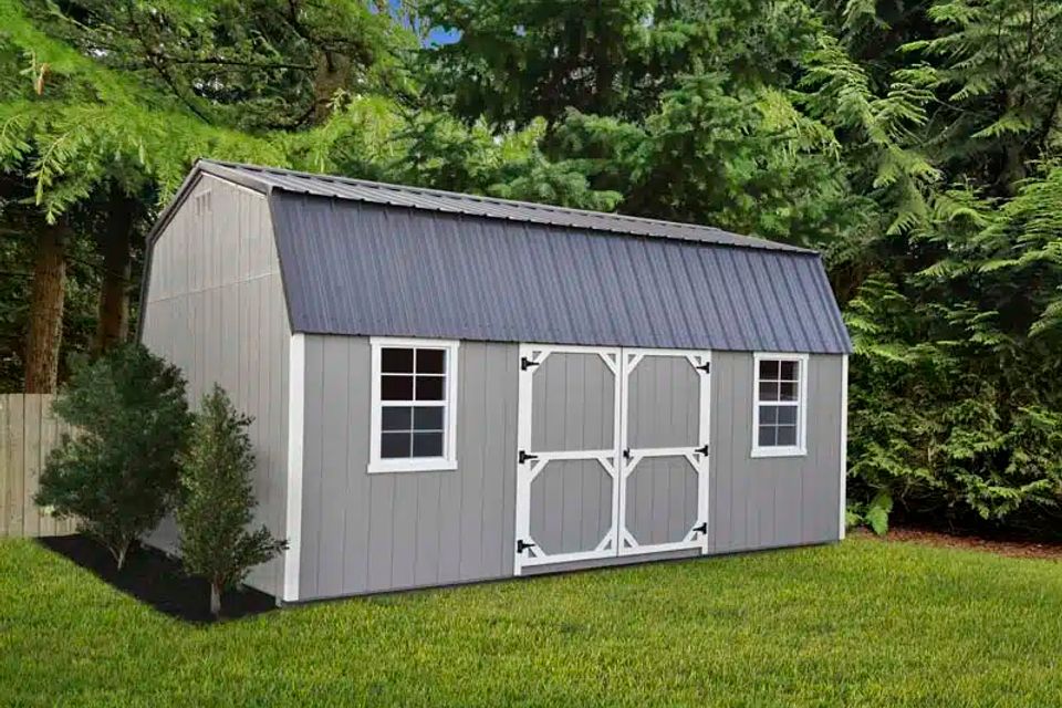 Gray high wall barn shed with white trim, windows and double doors on a Knoxville TN lawn