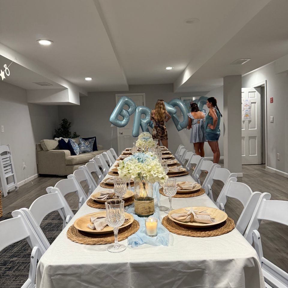 Coastal bridal shower table styling with blue balloon decor and hydrangea centerpieces in the Hamptons NY