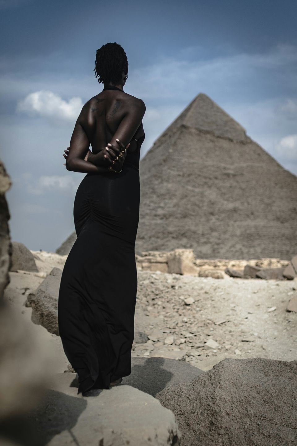 Photo of a woman looking at a pyramid in Egypt Lisa marie theck l5m1rbph4kq unsplash