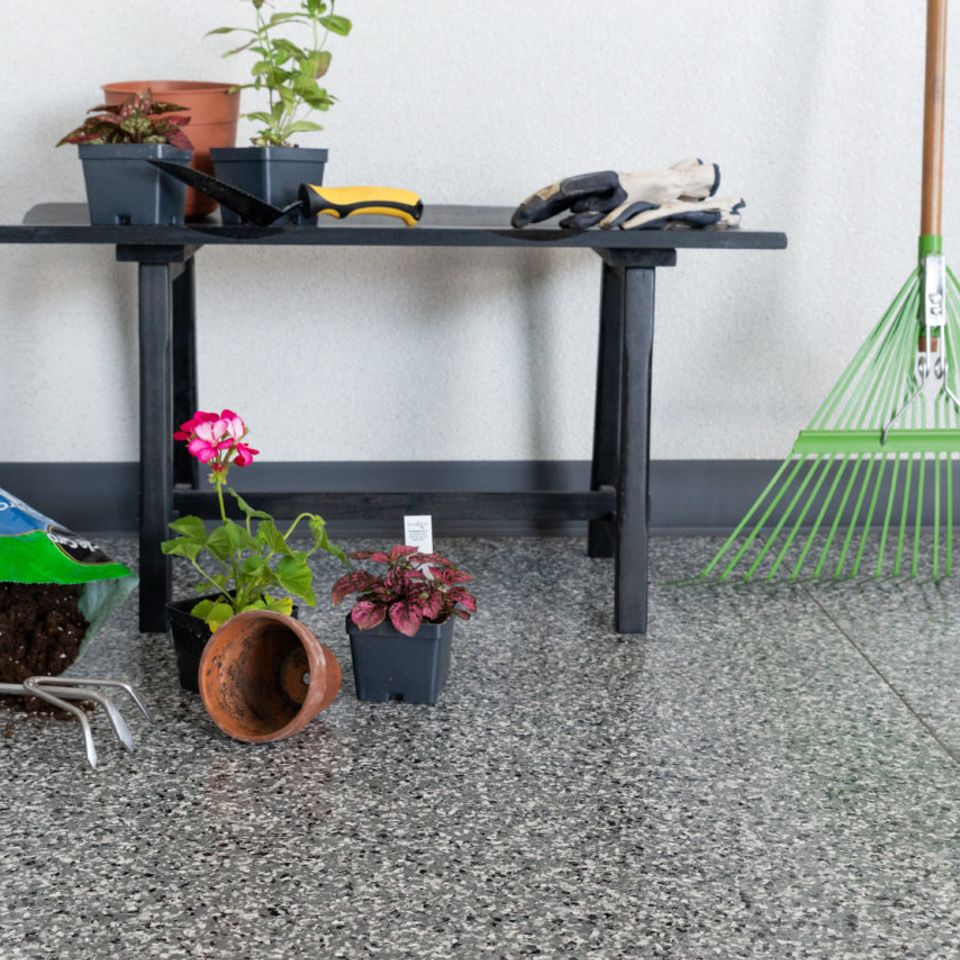 Gardening tools and potted plants on EverStone Flakes flooring.