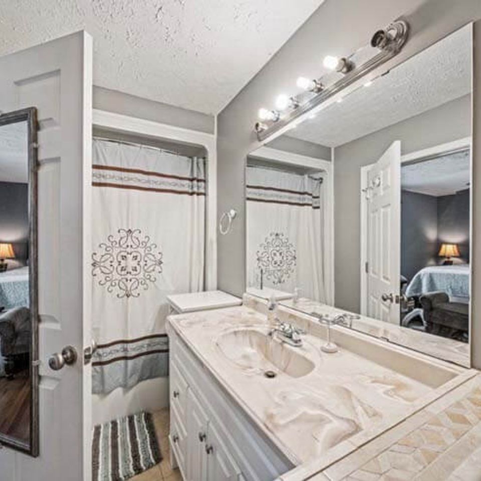 Stylish bathroom remodel with glass shower enclosure and tile flooring in Knoxville TN