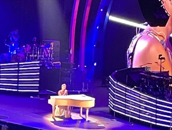 PINK playing a baby grand piano on stage 