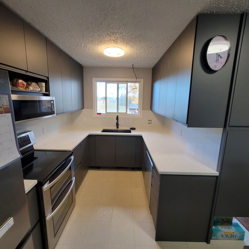 White counter with light and clock on wall