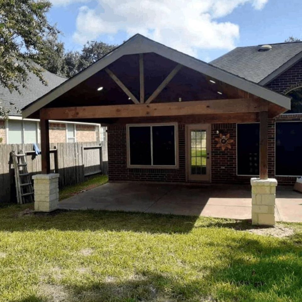 Completed covered back patio project cedar beam wood and stone posts