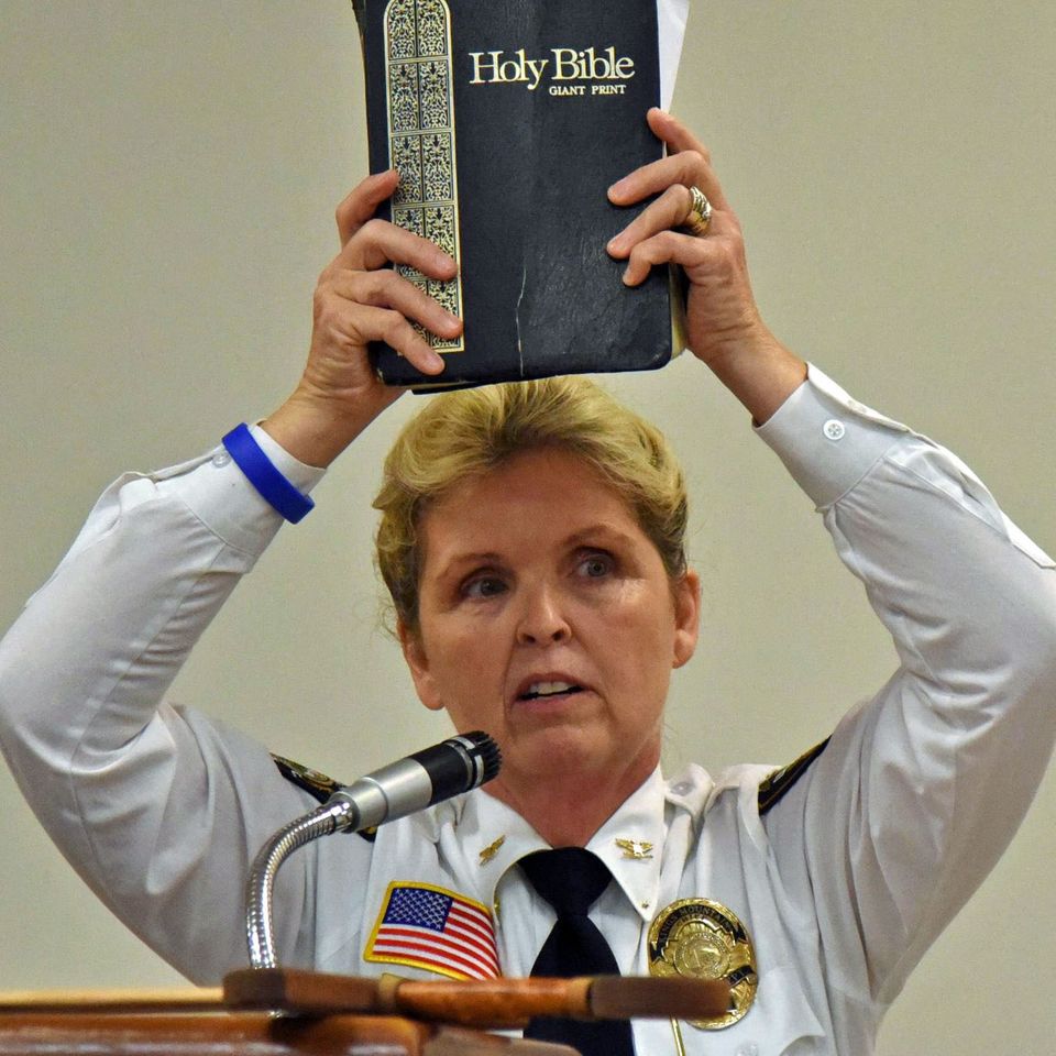 Chief holding bible
