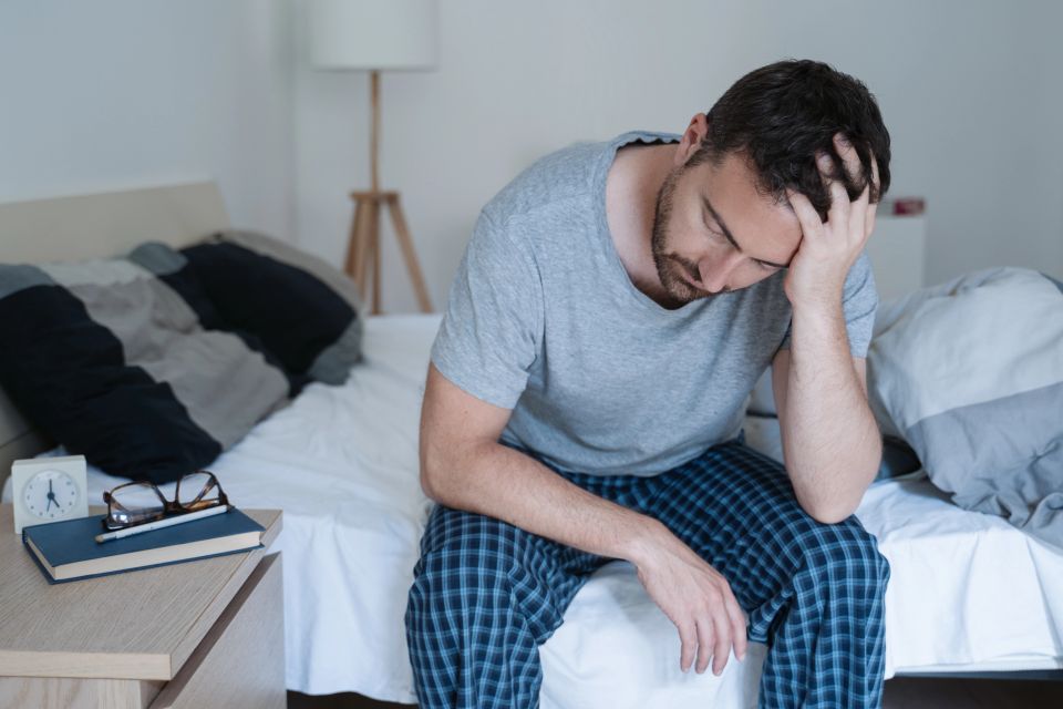 Man waking up early with headache possibly suffering from chronic fatigue