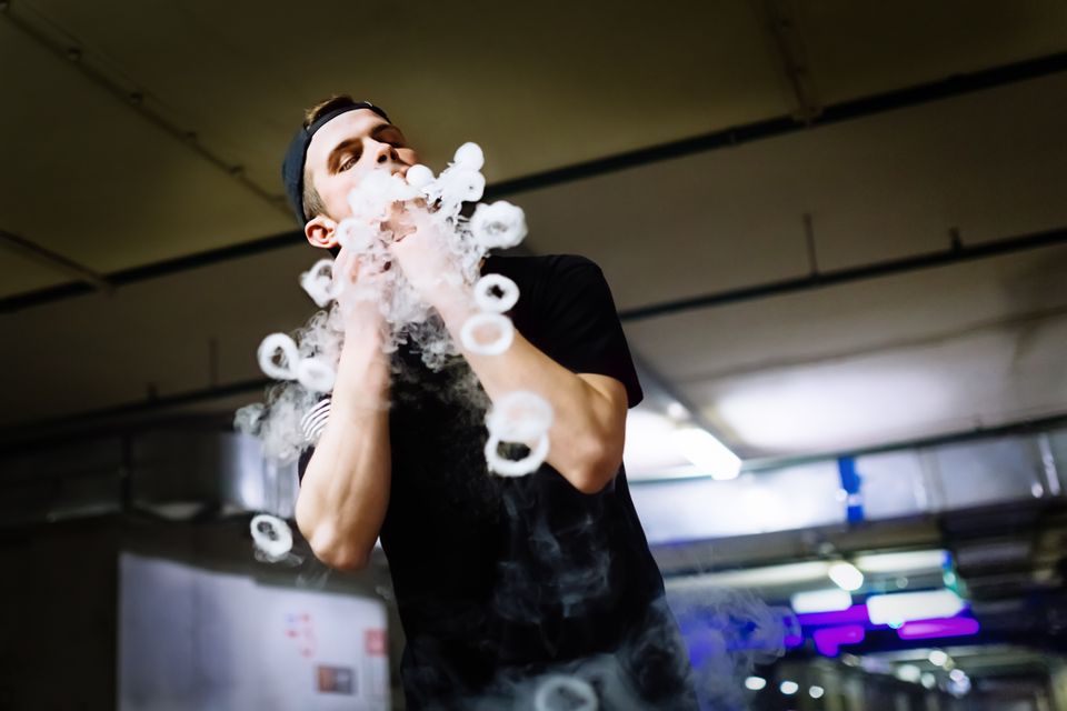 Vecteezy man in cap smoke an electronic cigarette and releases clouds 45602582