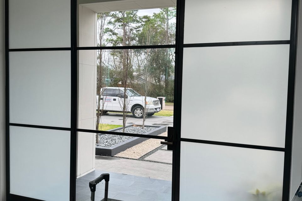 Frosted commercial window film installed on office building entrance doors in Sugar Land TX