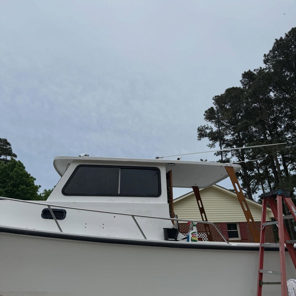 Downeast style boat with dark tinted cabin windows after marine tint in Moyock North Carolina