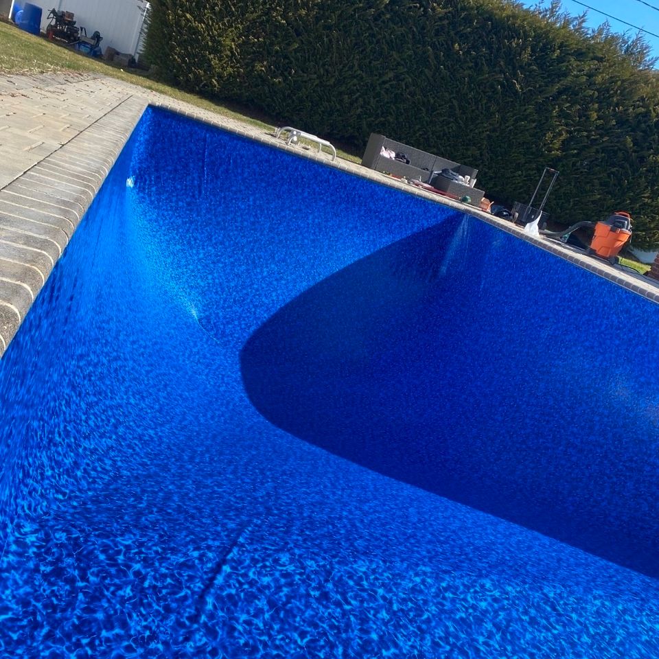 Freshly installed vinyl pool liner showing the deep end slope during a liner replacement in Long Island NY