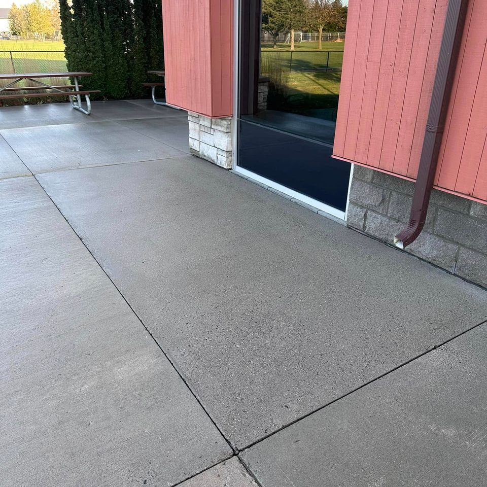 Evenly cleaned concrete walkway outside a community building after pressure washing in Tillsonburg Ontario
